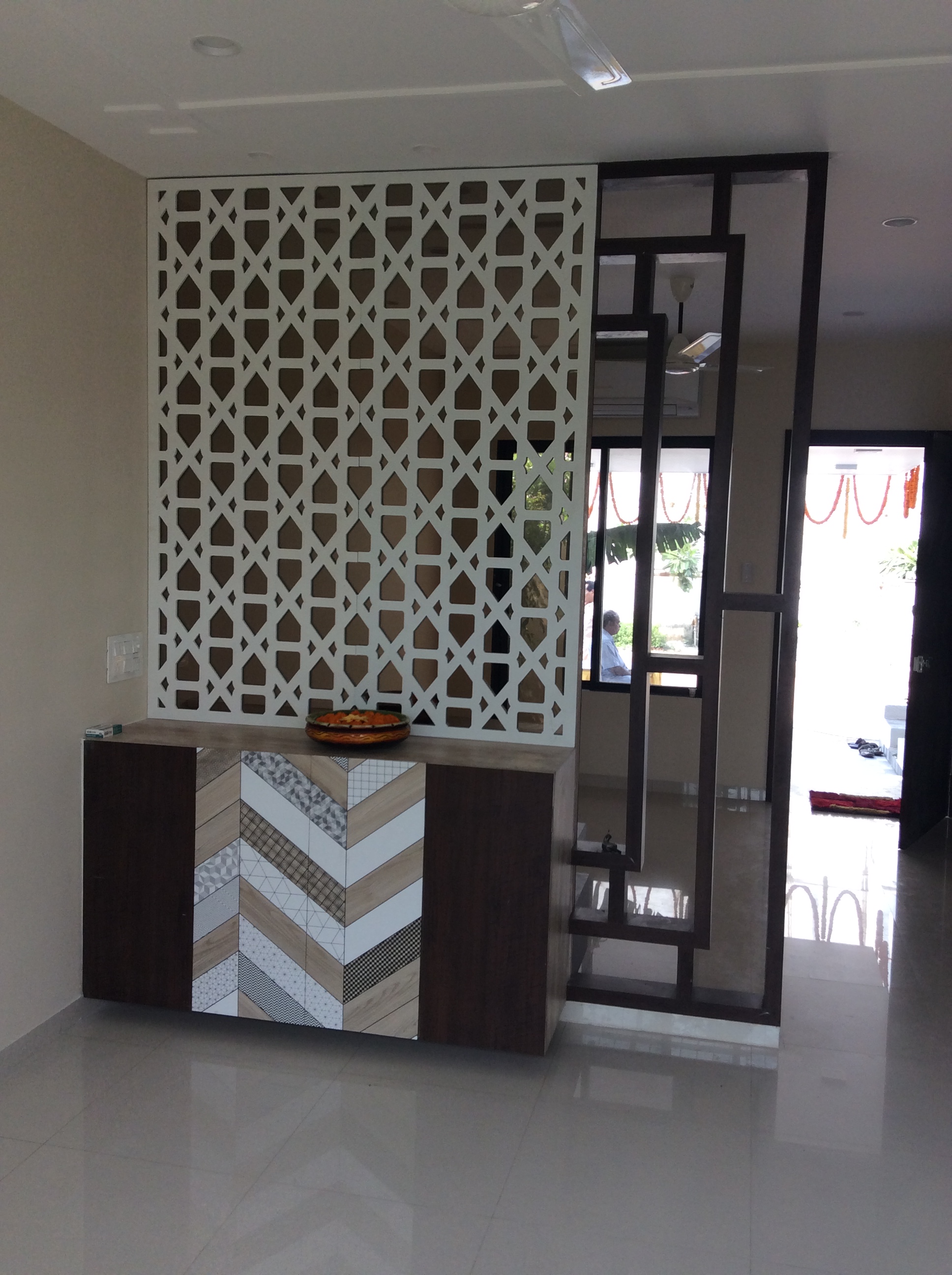 Home entrance foyer with a jaali partition and festive decor